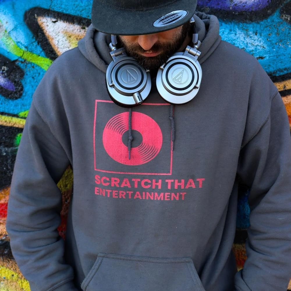 The Professor wearing headphones and a Scratch That Entertainment hoodie